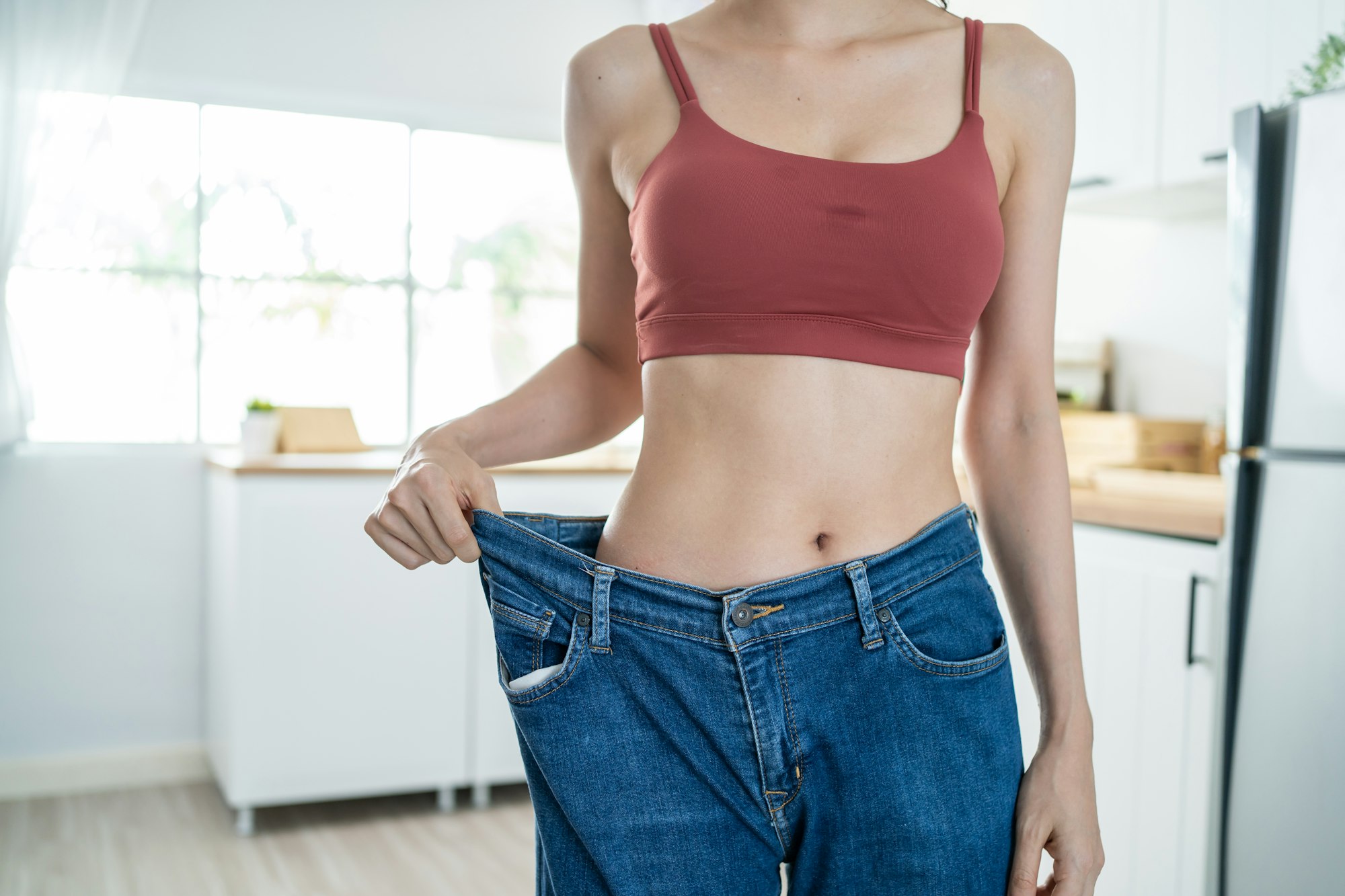 Close up of woman feel happy after lose weight for health in house.